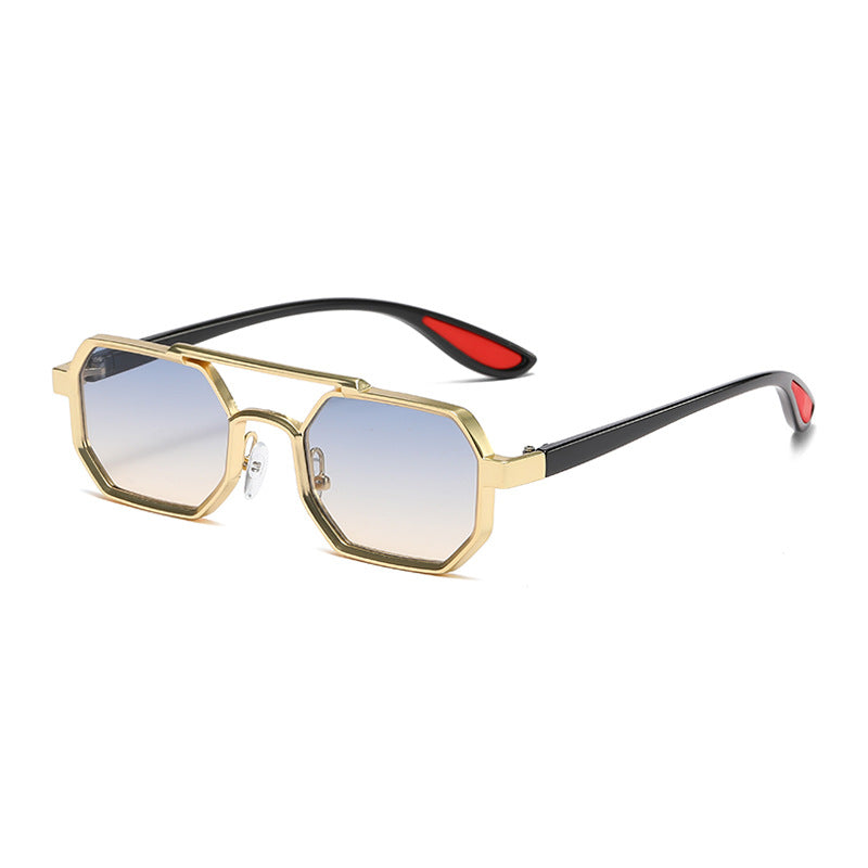 Sunglasses with gold frame and red accents on a white background